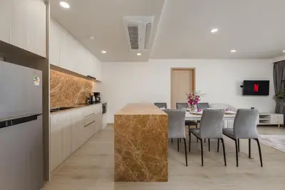 a kitchen and dining room with a table and chairs at Ozone Сondo Apart Hotel by TropicLook in Laguna Phuket