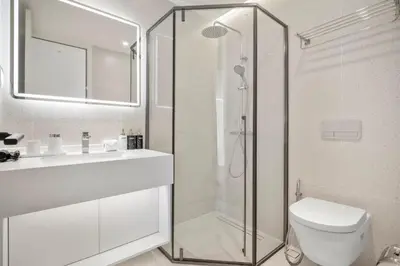 a bathroom with a shower and a toilet and a sink at Premier Kora 3-Bedroom Apartment E333 Beachfront in Phuket Town