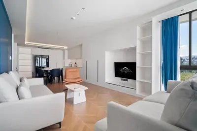 a living room with white furniture and a tv at Premier Kora 3-Bedroom Apartment E333 Beachfront in Phuket Town