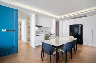 a kitchen and dining room with a table and chairs at Premier Kora 3-Bedroom Apartment E333 Beachfront in Phuket Town