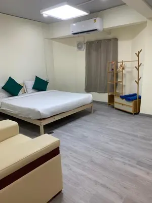 a hospital room with a large bed and a shelf at Uncle Yo House in Ban Tha Khreng
