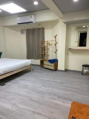 a room with a bed and a shelf in it at Uncle Yo House in Ban Tha Khreng