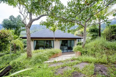 a small house with trees in front of it at A101 Banjong 1 Bed apart Near Nai Harn Beach in Rawai Beach