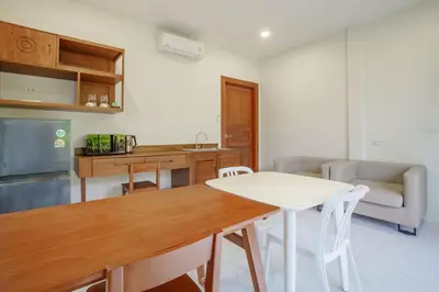 a kitchen and dining room with a table and chairs at A102 Banjong 1 Bed apart Near Nai Harn Beach in Rawai Beach