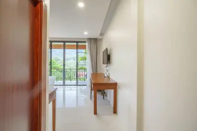a hallway with a desk and a room with a window at A102 Banjong 1 Bed apart Near Nai Harn Beach in Rawai Beach