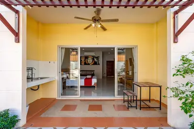 a kitchen and living room with a ceiling fan at Chernin Apartment Suites in Ban Saiyuan (1)