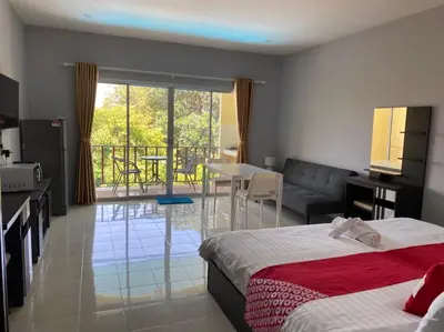 a hotel room with two beds and a living room at Chernin Apartment Suites in Ban Saiyuan (1)