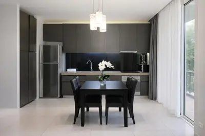 a kitchen with a black table and black cabinets at Zen Hilltop Nature Sanctuary Kamala Beach in Kamala Beach