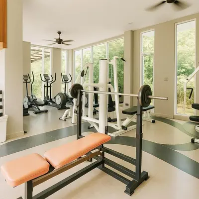 a gym with treadmills and ellipticals in a room at Zen Hilltop Nature Sanctuary Kamala Beach in Kamala Beach
