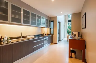 a kitchen with gray cabinets and a sink at Tropic Escape @ Baan Wana Phuket in Thalang