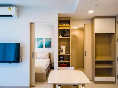 a room with a bed and a room with a tv at Двухкомнатные апартаменты Laguna Skypark in Laguna Phuket