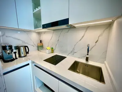 a kitchen with a sink and a counter top at Kora Beach 2Bdr 150 m to the Beach in Layan Beach