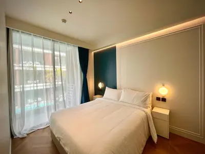 a bedroom with a large bed and a large window at Kora Beach 2Bdr 150 m to the Beach in Layan Beach