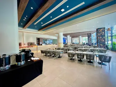 a dining room with tables and chairs in a building at Kora Beach 2Bdr 150 m to the Beach in Layan Beach