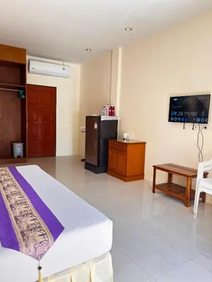 a hotel room with a bed and a tv at Ashiraya hostel in Kata Beach