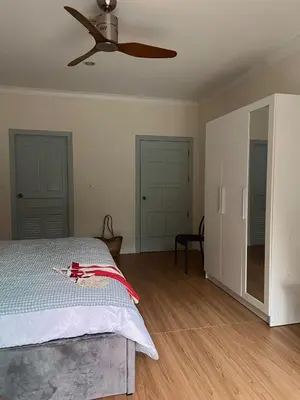 a bedroom with a bed and a ceiling fan at Roomy renovated Apartments in Phuket in Ban Sam Kong