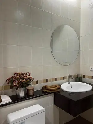 a bathroom with a sink and a mirror and a toilet at Roomy renovated Apartments in Phuket in Ban Sam Kong