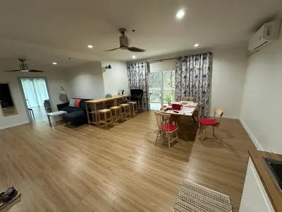 a living room with a couch and a table at Roomy renovated Apartments in Phuket in Ban Sam Kong