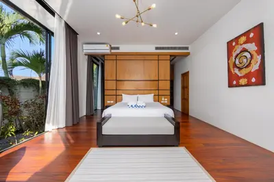 a bedroom with a bed and a large window at Aroha Villa with Private Pool Near Nai Harn Beach in Rawai Beach
