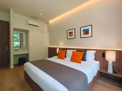 a bedroom with a large bed with orange pillows at Aileen Layan Villa 2 Private Pool 4Bedroom in Phuket Town