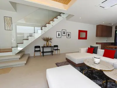 a living room with a white couch and stairs at Aileen Layan Villa 2 Private Pool 4Bedroom in Phuket Town