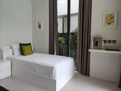 a bedroom with a white bed and a large window at Aileen Layan Villa 2 Private Pool 4Bedroom in Phuket Town