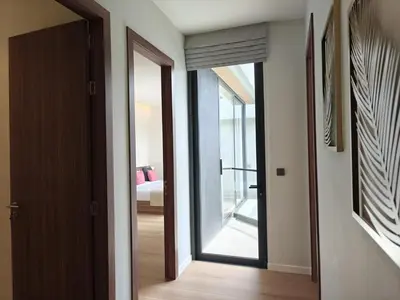 a hallway with a glass door leading to a bedroom at Aileen Layan Villa 2 Private Pool 4Bedroom in Phuket Town