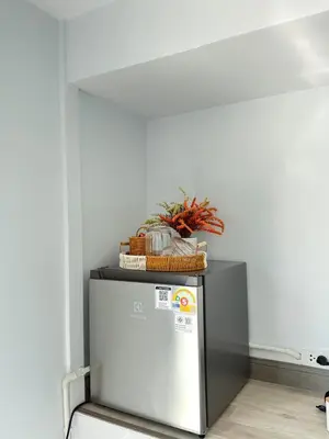a refrigerator with a basket of vegetables on top of it at Siriwan boutique hotel in Ban Met Nang Chi