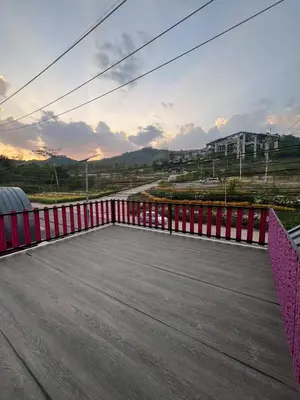 a balcony with a red fence and a road at Siriwan boutique hotel in Ban Met Nang Chi