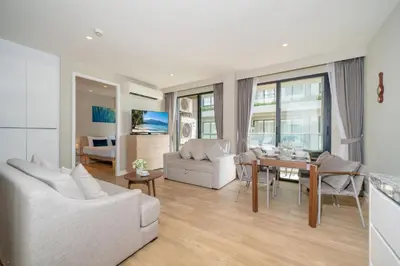 a living room with white furniture and a table at 2BR Apt 2510 Gem Resort near Bangtao Beach in Bang Tao Beach