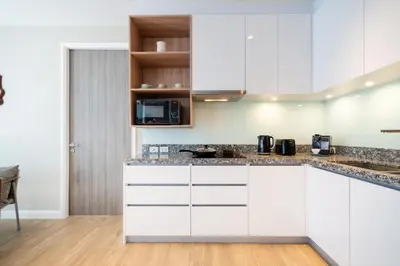 a kitchen with white cabinets and a counter top at 2BR Apt 2510 Gem Resort near Bangtao Beach in Bang Tao Beach