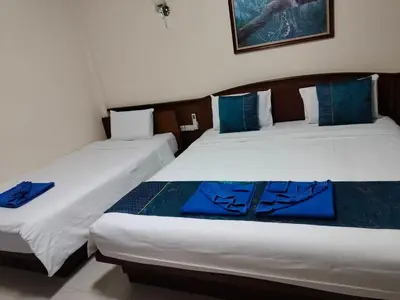 two beds sitting next to each other in a room at Patong \u4e00\u5367\u4e09\u4eba\u95f4 in Patong Beach