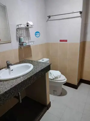 a bathroom with a sink and a toilet at Patong \u4e00\u5367\u4e09\u4eba\u95f4 in Patong Beach
