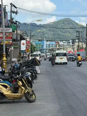 a row of motorcycles parked on the side of a street at Patong \u4e00\u5367\u4e09\u4eba\u95f4 in Patong Beach