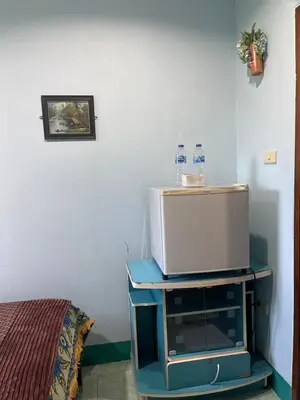 a tv sitting on a stand in a room at Rungtawan Hostel in Karon Beach