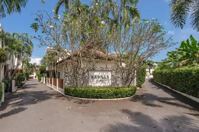 a building with a sign on the side of it at Tropical Rawai Beach Home Retreat with Pool & Gym in Rawai Beach