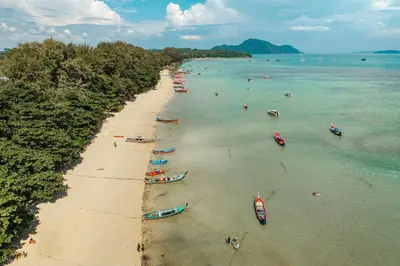 an aerial view of a beach with boats in the water at Tropical Rawai Beach Home Retreat with Pool & Gym in Rawai Beach