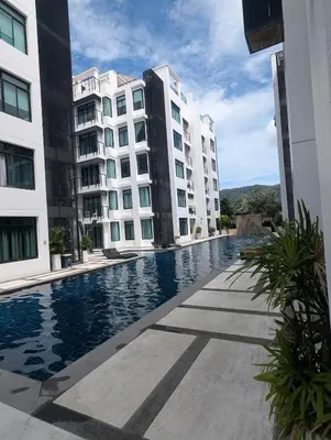 a swimming pool in the middle of a building at Large 1 Bed Condo in Kamala Regent, Close to Beach in Kamala Beach