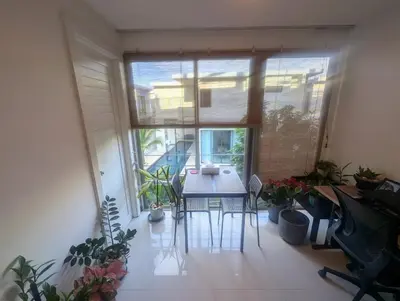a room with a table and chairs and plants at Large 1 Bed Condo in Kamala Regent, Close to Beach in Kamala Beach