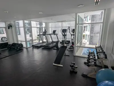 a gym with treadmills and machines in a building at Large 1 Bed Condo in Kamala Regent, Close to Beach in Kamala Beach