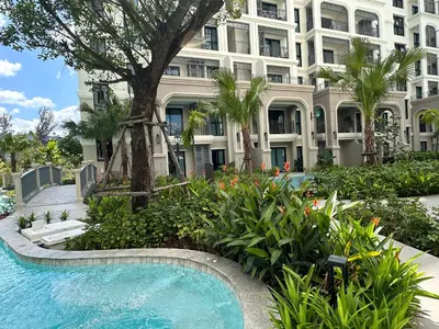 a swimming pool in front of a large building at 1BR Apartment near Bang-Tao Beach CapitalPro TLB-H206 in Bang Tao Beach
