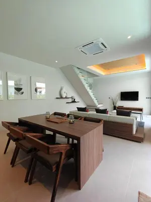 a living room with a table and a couch at Aileen Layan Villa 3 Private Pool 4 Bedroom in Phuket Town