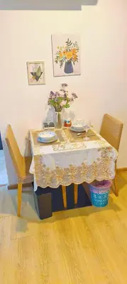 a table with two chairs and a table with flowers on it at cen807 in Phuket Town