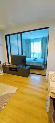 a bedroom with a bed and a large mirror at cen807 in Phuket Town