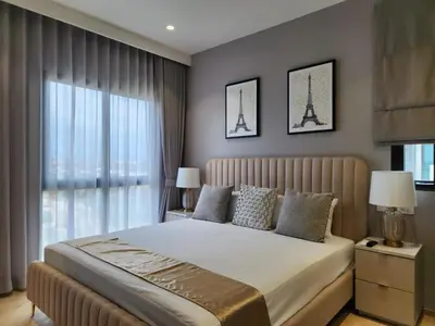 a bedroom with a bed with the eiffel tower at WEG Title Legendary in Bang Tao Beach