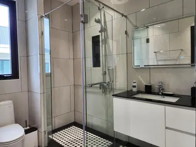 a bathroom with a glass shower and a sink at WEG Title Legendary in Bang Tao Beach