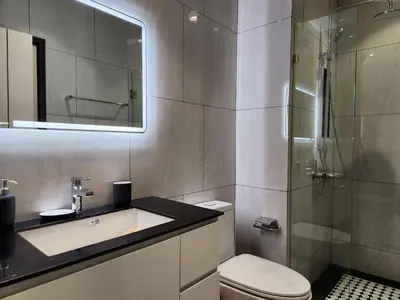 a bathroom with a toilet and a sink and a shower at WEG Title Legendary in Bang Tao Beach