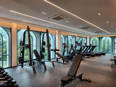 a gym with a row of treadmills and ellipticals at WEG Title Legendary in Bang Tao Beach
