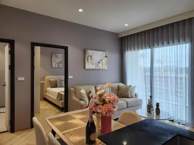 a living room with a table and a couch at WEG Title Legendary in Bang Tao Beach