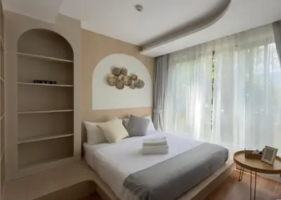 a bedroom with a large bed and a window at New apartment at Fantasea Kamala by Lofty in Kamala Beach